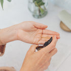 Person applying a product to their hand with a blurred background